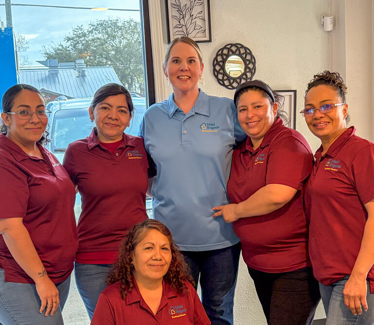 Team of happy cleaning techs smiling together